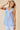 V-neck Baby doll Sleeveless Blouse with Ruffle Top worn by model, showcasing ruffle detail and flowy silhouette.