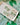 Clover Bow Earrings Shamrock Bow Earrings Lucky Bow displayed on a plate with shamrock background.