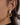 Close-up of Anémone 18K Gold Non-Tarnish Pearl Drop Earrings worn on the ear