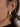 Close-up of Anémone 18K Gold Non-Tarnish Pearl Drop Earrings worn on the ear