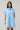 Model wearing Saida Striped Kenda Shift Mini Dress in blue and white stripes, front view