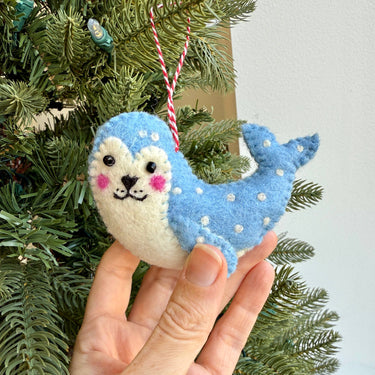 Leopard Seal Felt Wool Christmas Ornament held by hand
