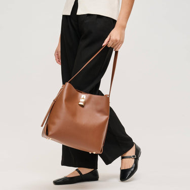 Caroline Hobo Chocolate bag carried on shoulder, showcasing its stylish hobo design.