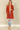 Shop Wall rust orange long sleeve open front cardigan with side pockets worn by a smiling blonde model