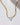 Prism Gems Birthstone Necklace - December featuring an emerald-cut blue topaz on a geometric link chain.