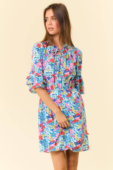 Floral Printed Split V-Neck Half Bell Sleeve Dress model wearing colorful floral dress with ruffles and half sleeves.