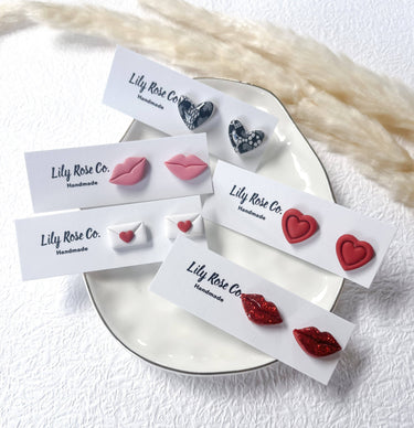 Hearts and Valentine’s Stud Earrings displayed on a plate, showcasing unique handcrafted designs by Lily Rose Co.