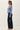 Side view of model wearing blue Ultra Soft Essential Basic Crewneck Button Up Cardigan with pants