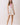 Floral Print Sleeveless Tiered Babydoll Dress featuring a V-neckline and tiered skirt, modeled by a woman in pink sandals.