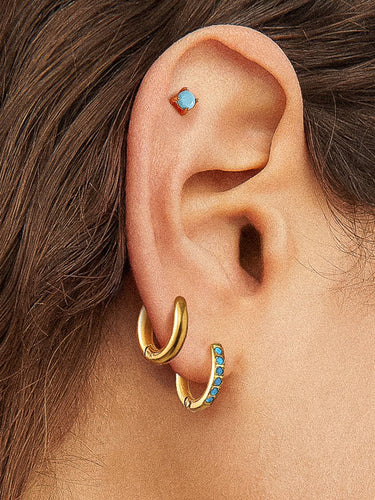 Ivalo 18K Gold Non-Tarnish Turquoise Huggie Earring Set displayed on ear model with gold and turquoise details.