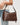 Waylon Shoulder Bag Chocolate carried over the shoulder, showcasing its rich brown color.