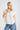 White collared V neck button down line lace detail shirt with blue denim jeans