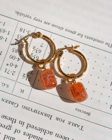 Pill Drop Hoop Earrings- Sunstone featuring gold hoops and smooth sunstone gemstones.