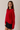 Side view of model wearing red Round Rolled Hemline Detail Thin Sweater Cardigan with black shorts