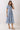 Embroidered Floral Tiered Button Down Midi Dress in blue with a collared neckline and tiered skirt on a model.