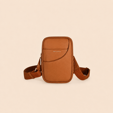 Vegan leather mini crossbody bag in tan with adjustable strap, ideal for stylish, sustainable fashion.