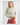 Front view of model wearing Irisha oatmeal diamond pointelle sweater with red pants