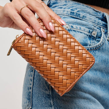 Jocelyn Wallet Tan held in hand, showcasing its quilted texture and compact design.