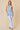 V-neck Baby doll Sleeveless Blouse with Ruffle Top worn by model, showcasing vertical ruffle detailing in light blue.