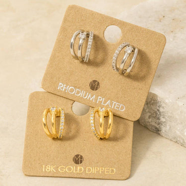 Pave Layered Hoop Huggie Earrings displayed in rhodium plated and 18k gold dipped styles on a card.