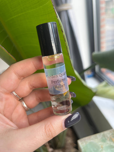 Garden Quartz Crystal Perfume Roller held in hand, showcasing its refreshing fragrance and natural ingredients.