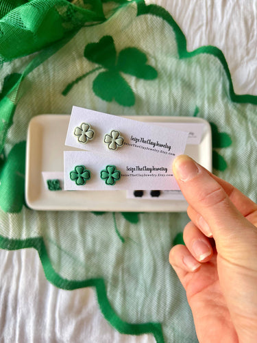 Clover Studs Shamrock Earrings Pot of Gold Studs displayed on a plate with a green scarf background.