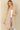 Shop Wall beige long sleeve open front cardigan with side pockets worn by a smiling woman