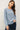 Model wearing blue raglan sleeve slub pullover sweater, front view