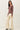 Side view of model wearing dusty mauve Ultra Soft Boatneck Basic Long Sleeve Top with cream pants