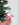 Pink felt flying pig keychain displayed with green foliage