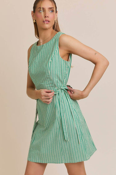 BOAT NECK SLEEVELESS SIDE TIES MINI DRESS model wearing size small in green striped fabric