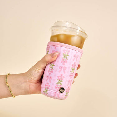 Sip Savvy Drink Sleeve Large Oh So Fancy Pink holding a cold beverage in a stylish sleeve with floral design.