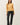 Front view of model wearing yellow button-up cardigan with black pants