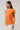 Donna Dot Hessi Button Down Top in vibrant orange with floral print and ruffled cap sleeves