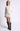 Model wearing white Chiara long-sleeve pullover sweater with black pants