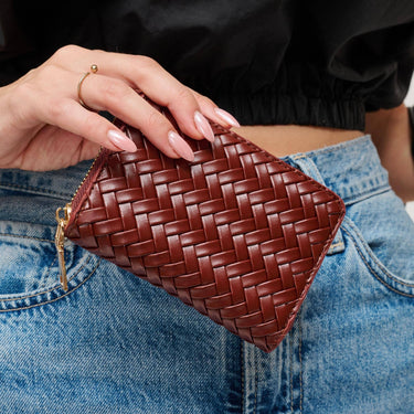 Jocelyn Wallet Chocolate with quilted texture held in hand.