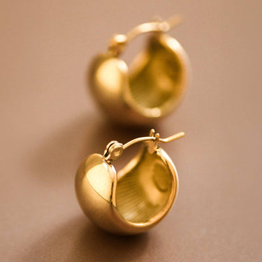 18K Gold Plated Waterproof Stainless Steel Hoop Earrings 7463 displayed as a pair on a warm brown background