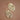 Gold Plated Metal Leaf Drop Earrings 7418 displayed as a pair on a brown background