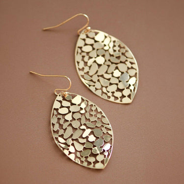 Gold Plated Metal Leaf Drop Earrings 7418 displayed as a pair on a brown background