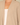 Shop Wall beige open front long sleeve cardigan with a soft knit texture layered over a white top