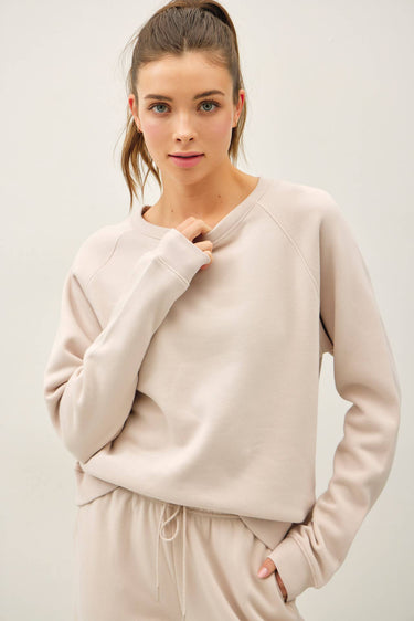 Model wearing stone garment-washed cotton modal fleece sweatshirt, front view