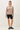 Model wearing stone cotton modal fleece sweatshirt with black shorts, front view