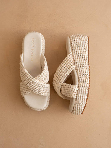 The Fresno Ivory Raffia Platform Sandal from Oasis Society with a chunky basket weave design and slip-on closure.