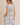 BACK VIEW OF ROUND NECK RUFFLE SHORT SLEEVE FLORAL PRINT DRESS ON MODEL