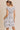 BACK VIEW OF ROUND NECK RUFFLE SHORT SLEEVE FLORAL PRINT DRESS ON MODEL