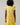 Back view of a model wearing the Joni Floral Yodi Shift Mini Dress in yellow floral print with ruffle sleeves.