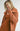 Close-up of model wearing Elianna rust wide collar cardigan