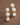 18K Gold PVD Plated Waterproof Stainless Steel Stud Earrings 7093 displayed vertically on a brown background