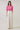 Model in a Mirany Ikat Bindy Puff Sleeve Top, featuring puff sleeves and ruffle neckline, paired with light pants.