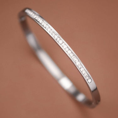 Tarnish-Resistant Waterproof Stainless Steel Bangle 7040 displayed diagonally on a brown background
